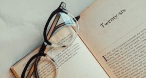 Image of reading glasses on top of an open book