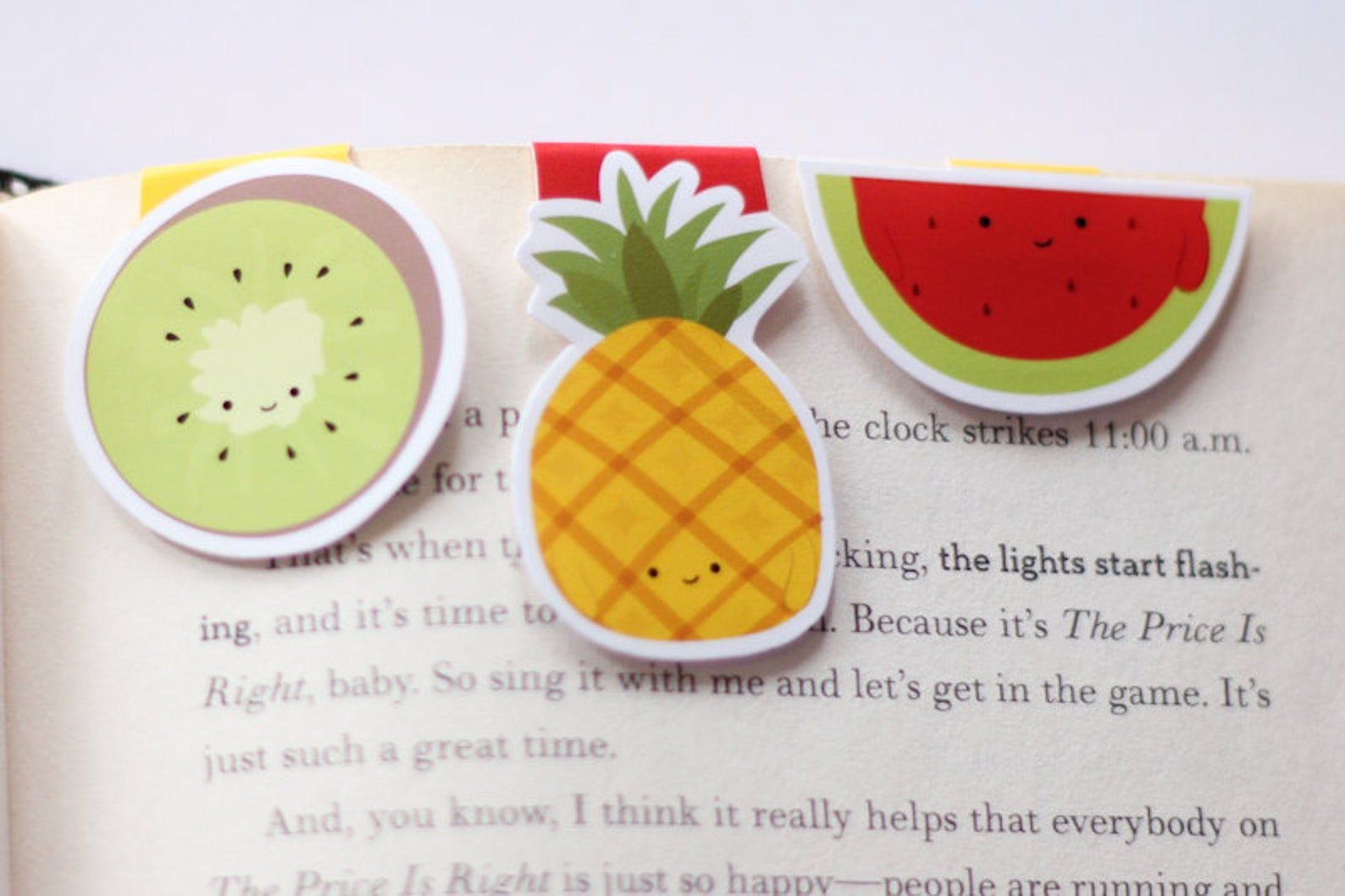 Kiwi, pineapple, and watermelon mini magnetic bookmarks in a row. 