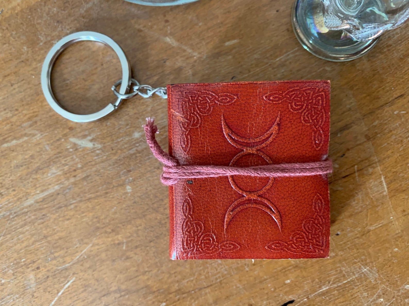 Image of small red journal on a keychain. 