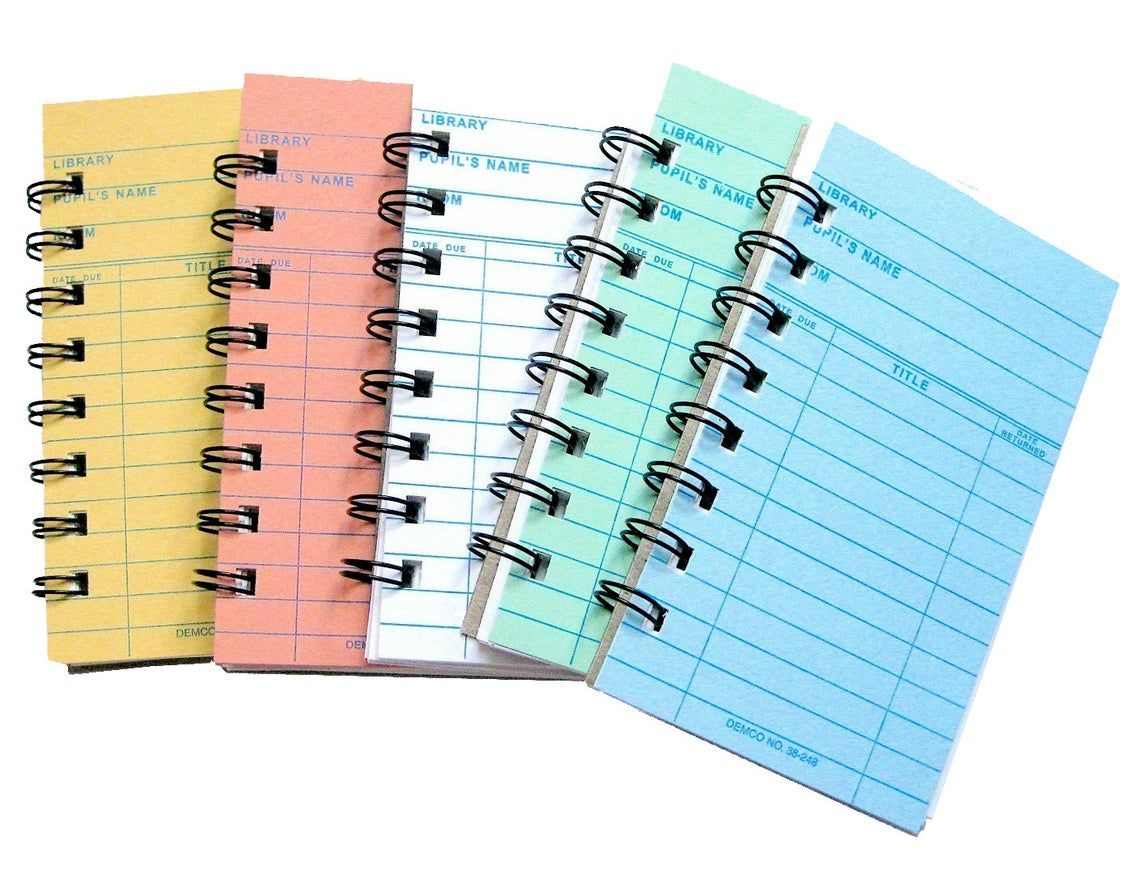 small notebooks with pastel colored library cards as covers 