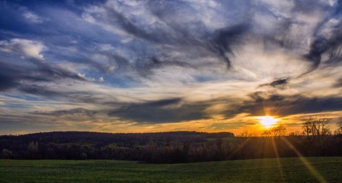 green grass field under cloudy sky at sunset https://unsplash.com/photos/Y5lV93pBqUw