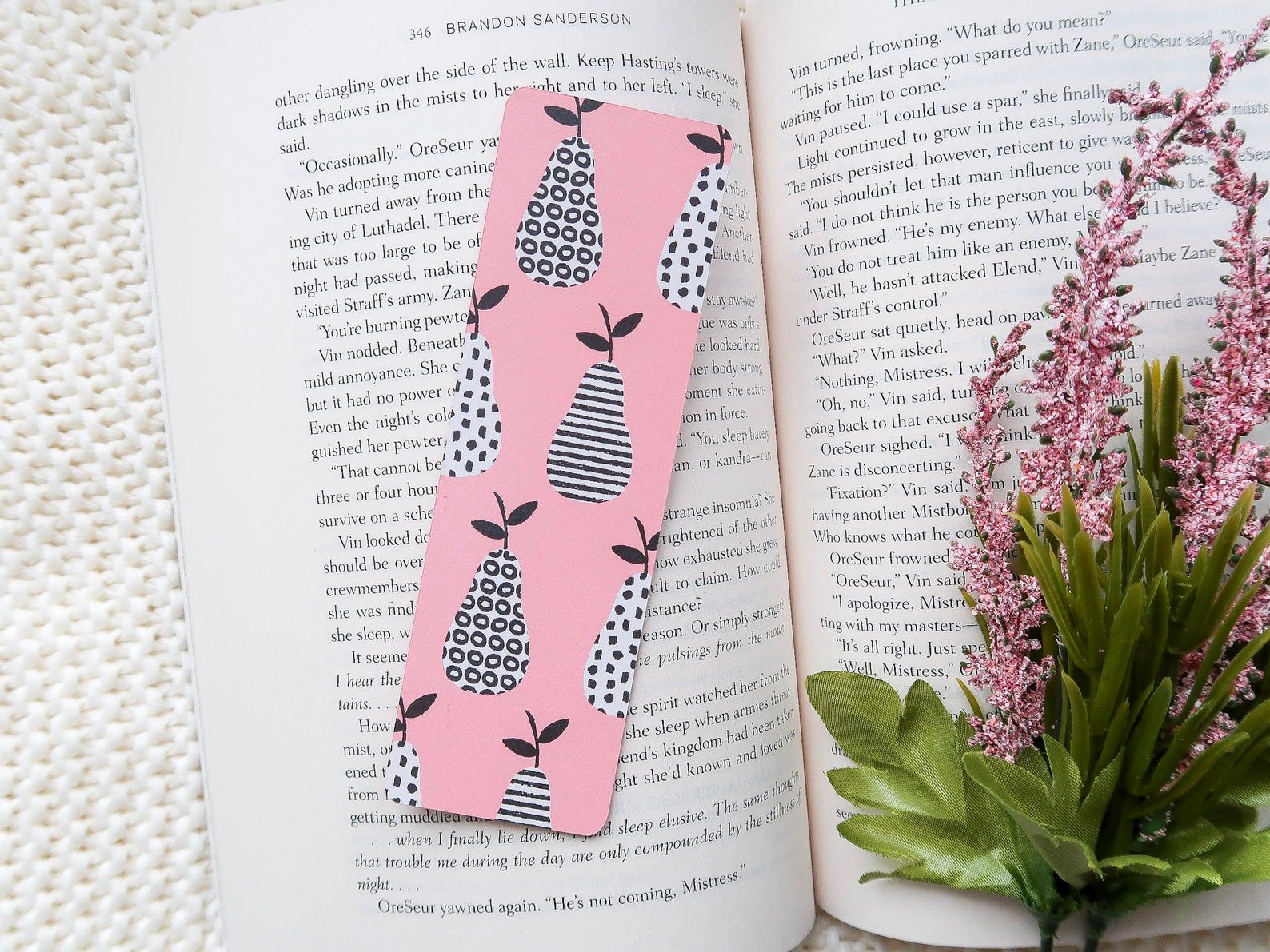 Image of a pink bookmark with black and white patterned pears. 