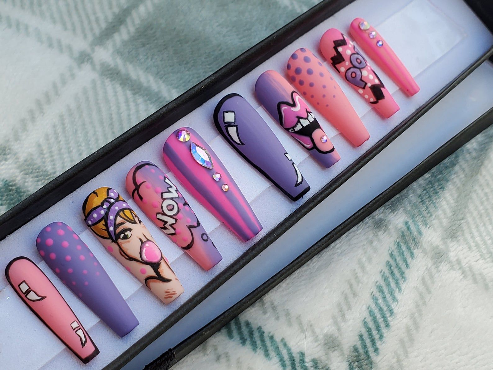 Image of long nails featuring bright pop comic art.