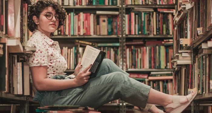 reading on floor of bookstore https://www.pexels.com/photo/woman-sits-on-the-floor-inside-library-2167683/