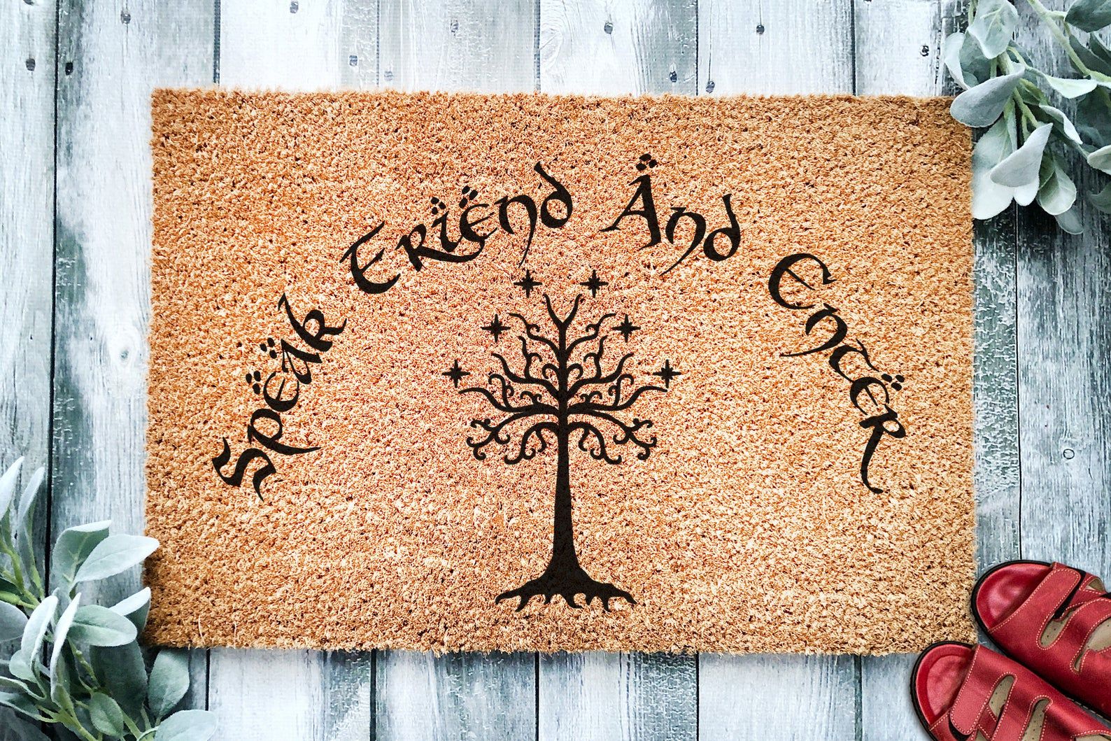 Doormat with words "Speak Friend and Enter" in black and a tree in the middle. 