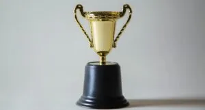 gold trophy with a black base/mount https://unsplash.com/photos/_XTY6lD8jgM