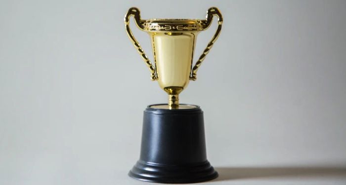 gold trophy with a black base/mount https://unsplash.com/photos/_XTY6lD8jgM