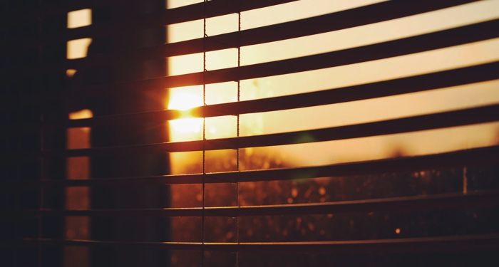 sunset as seen from behind dark window blinds https://unsplash.com/photos/UW6MVp5nOas