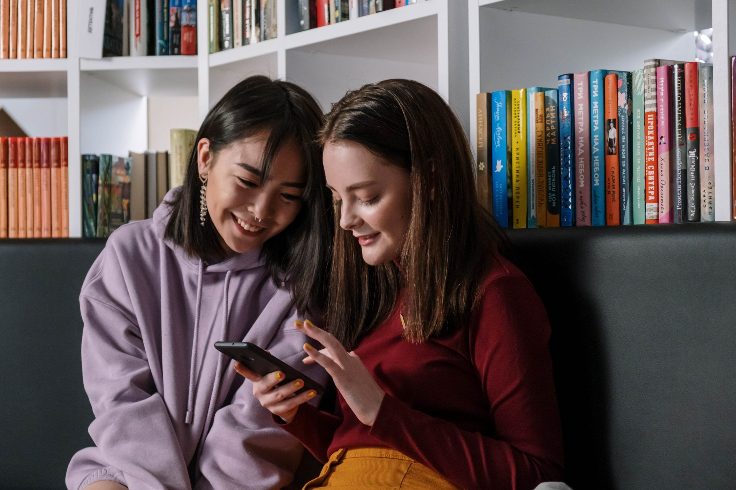 teenagers in front of bookcase