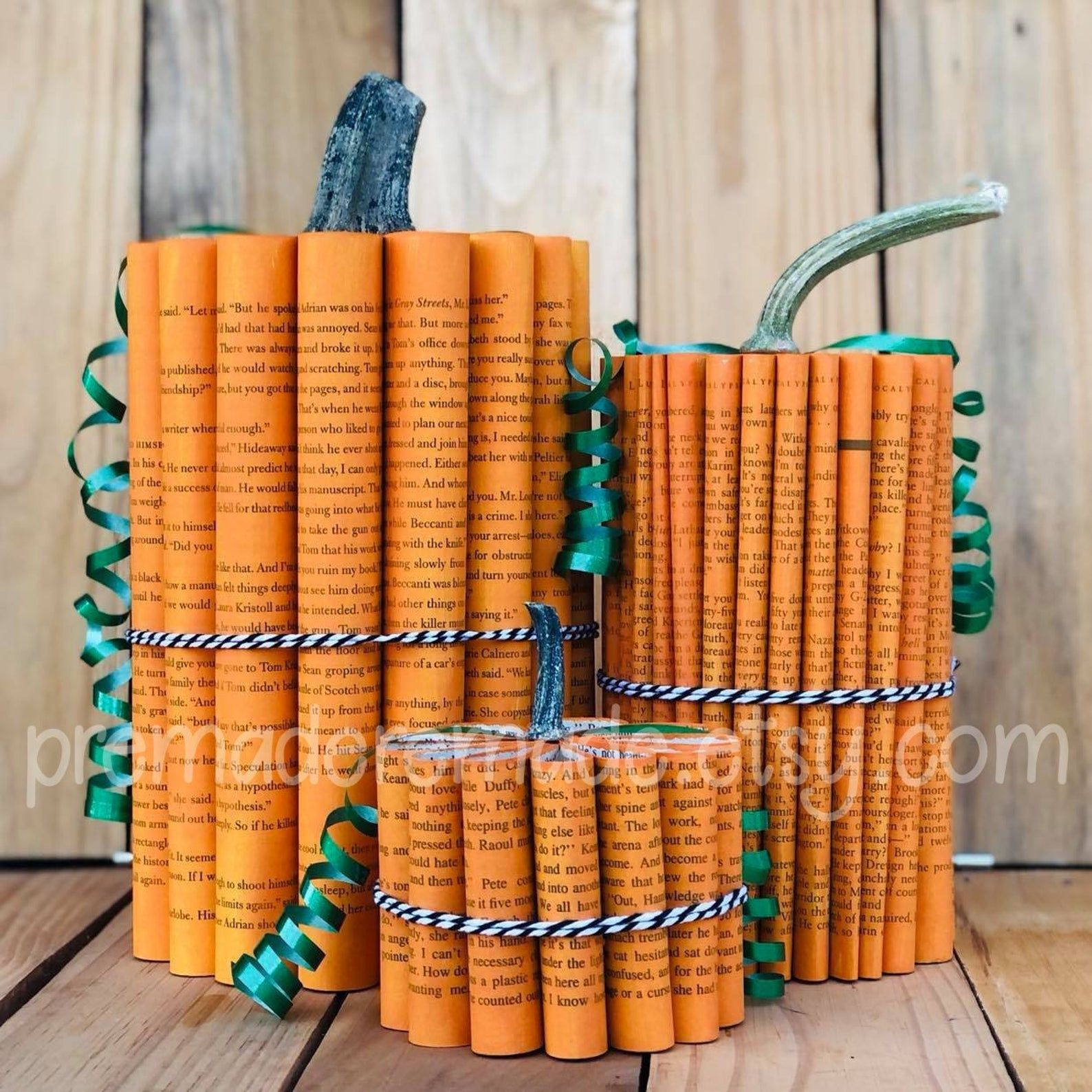 Three pumpkins made of recycled book pages. 