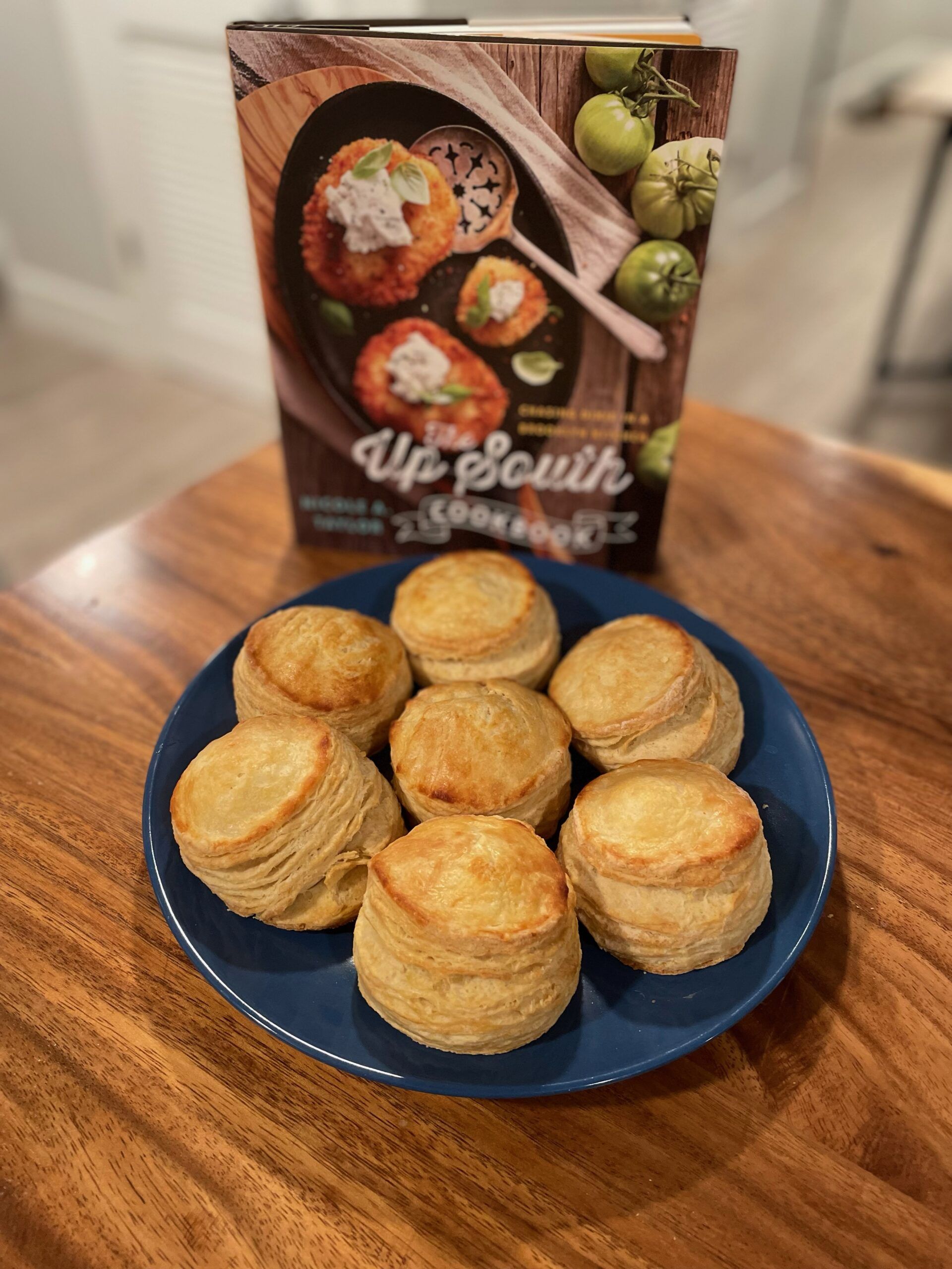 The Up South Cookbook with a plate full of buttermilk biscuits