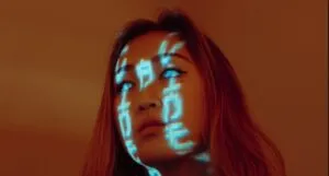 Futuristic image of young Asian woman with orange hair and milky eyes and Chinese writing characters made of light over her face