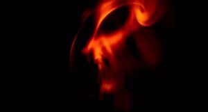a fiery demonic face against a black background