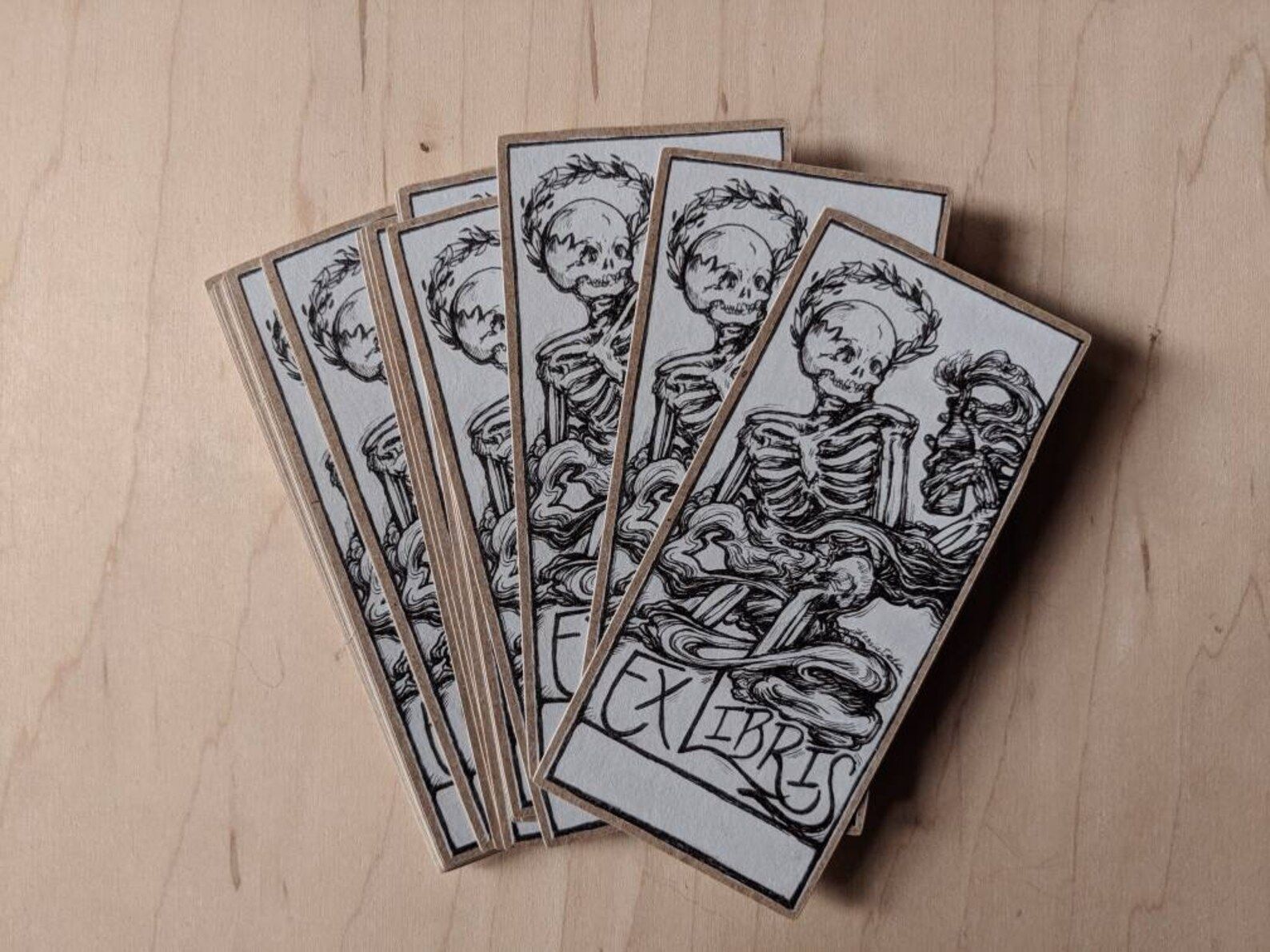 Image of book stamp stickerrs with a skeleton and the words "Ex Libris" beneath. 