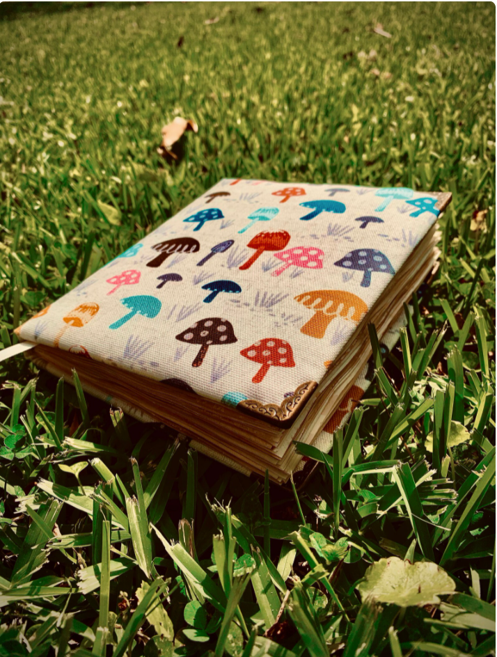 Mushroom notebook with a cream background, made of fabric. 