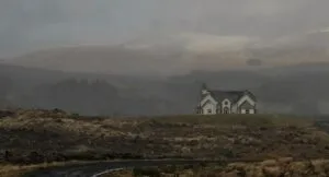 Image of a lone white house on a deserted road