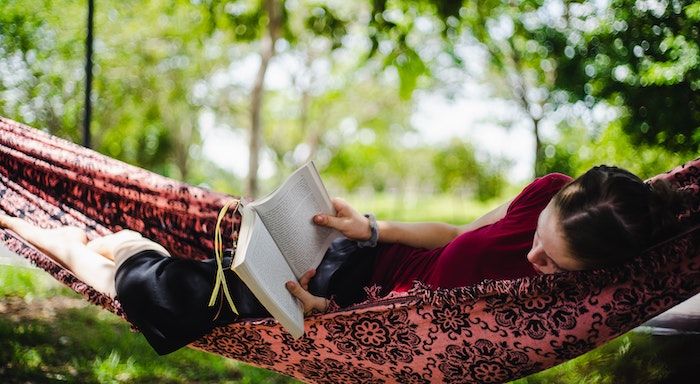 Image of a Teenager Reading In a Hammock