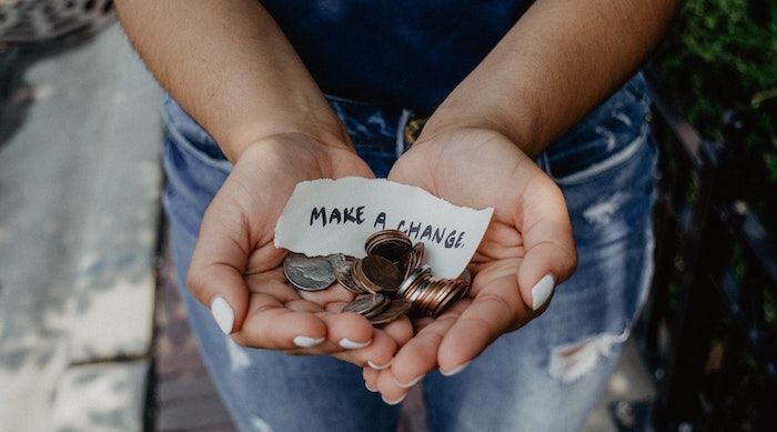 image of hands holding change and note reading "make a change."