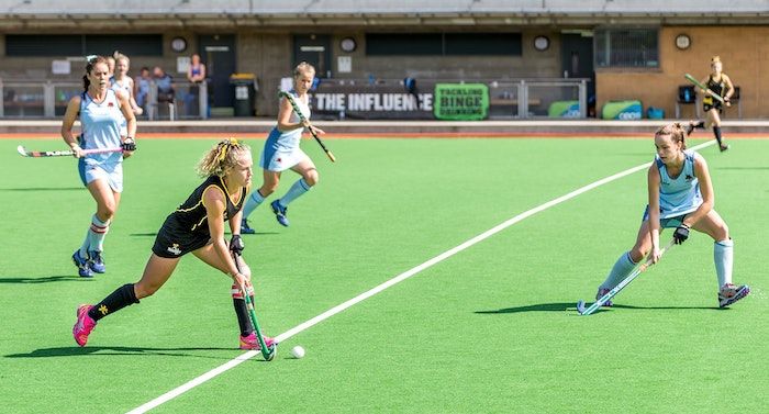 Image of Teen Girls Playing Field Hockey