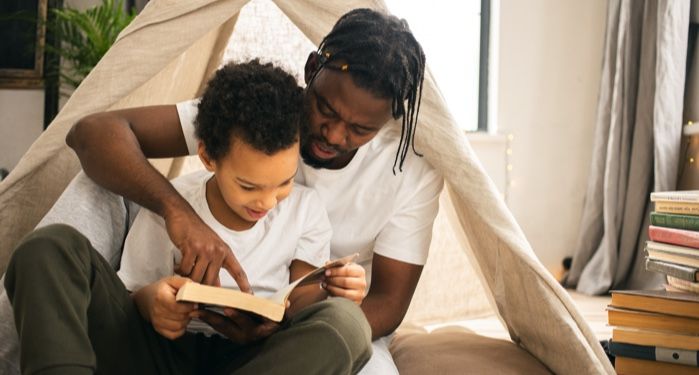 a parent reading a novel-length book to a child