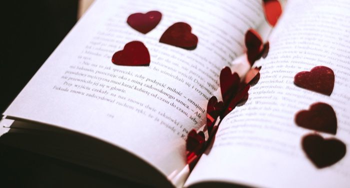 red metallic heart cutouts inside an open book