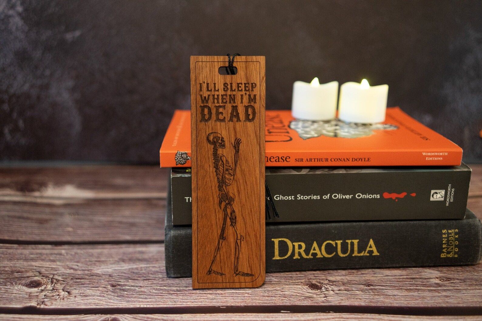 Image of a wooden bookmark with a skeleton. Above the skeleton, it reads "I'll sleep when I'm dead." 