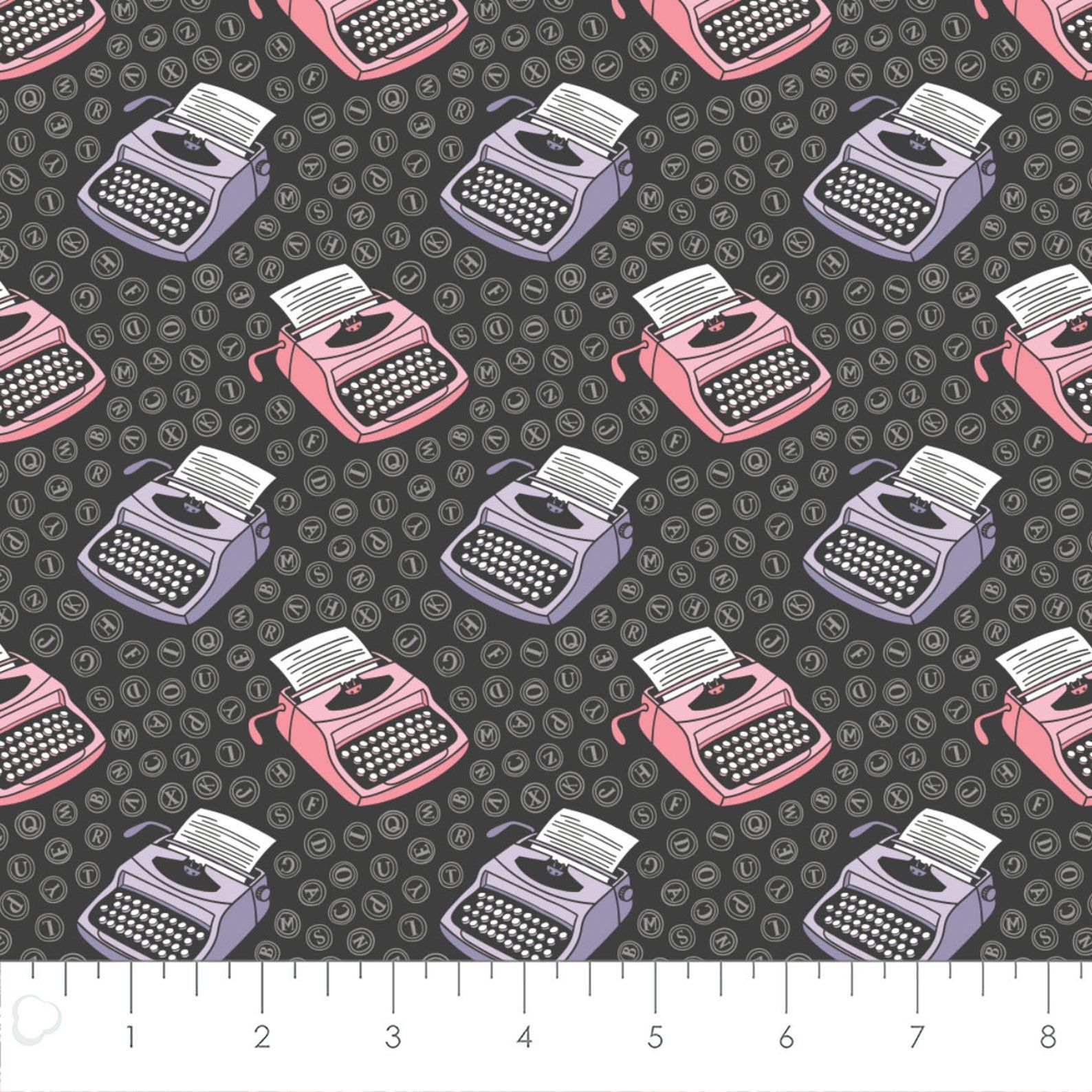 Dark gray fabric with pink and purple typewriters and typewriter keys 