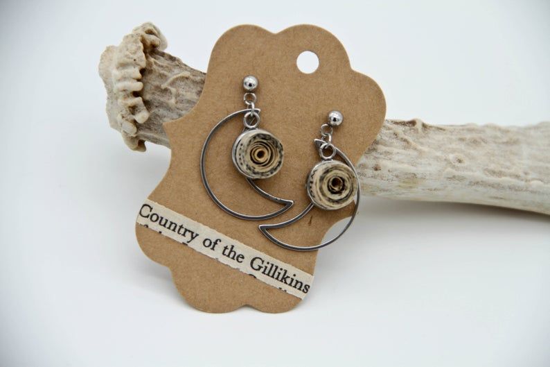 Image of moon earrings with quilled book pages. 