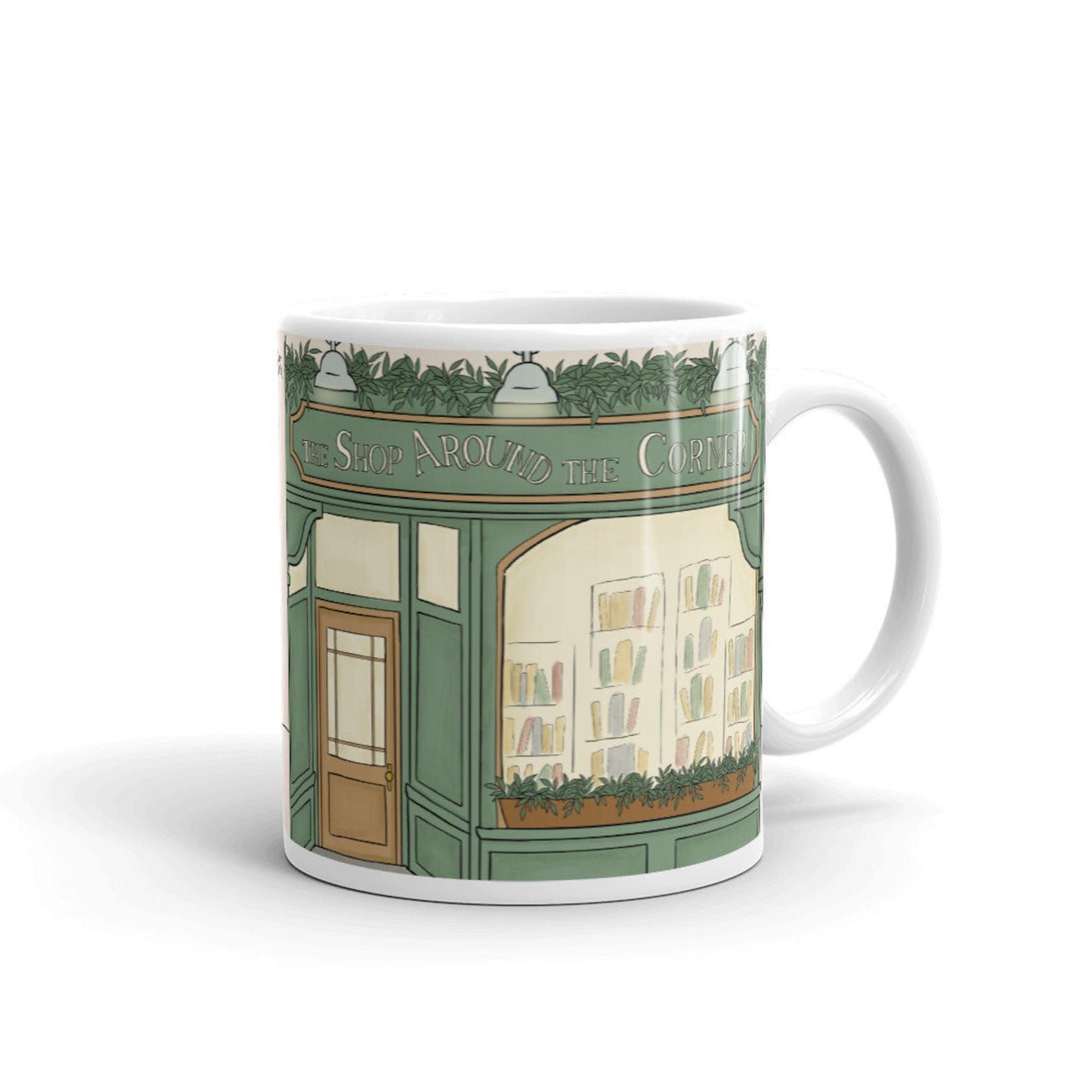 A mug with an image of the storefront of The Shop Around the Corner from the movie You've Got Mail.