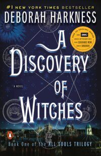 Book cover for A Discovery of Witches, featuring the title in white laid over the night sky. The skyline of Oxford is in the foreground and there are constellation symbols in the night sky.