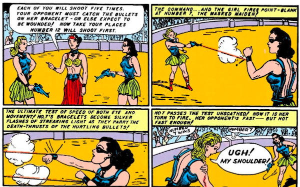 Four panels. Panel 1: Diana, wearing a mask, and a blonde Amazon face off in an arena, both holding pistols, with Hippolyta presiding. Hippolyta: Each of you will shoot five times. Your opponent must catch the bullets on her bracelet - or else expect to be wounded! Now take your places. Number 12 will shoot first. Panel 2: The blonde shoots at Diana, who deflects the bullet with her bracelet. Narration Box: The command...and the girl fires point-blank at Number 7, the masked maiden! Panel 3: Diana deflects two more bullets. Narration Box: The ultimate test of speed of both eye and movement! No. 7's bracelets become silver flashes of streaking light as they parry the death-thrusts of the hurtling bullets! Panel 4: The blonde grips her bleeding shoulder as the crowd cheers. Narration Box: No. 7 passes the test unscathed! Now it is her turn to fire. Her opponent's fast - but not fast enough! Blonde: Ugh! My shoulder!