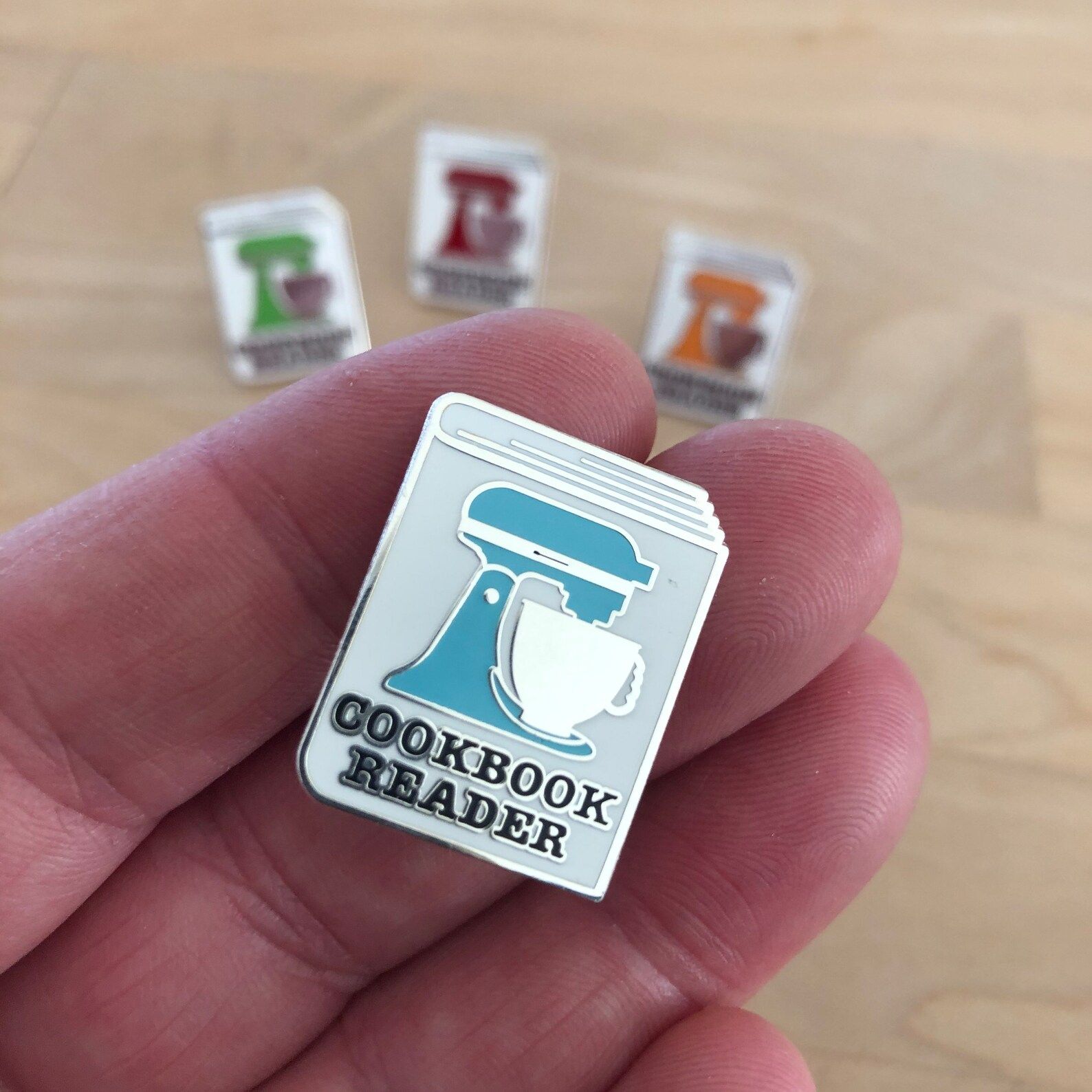 Image of "cookbook reader" blue enamel pin