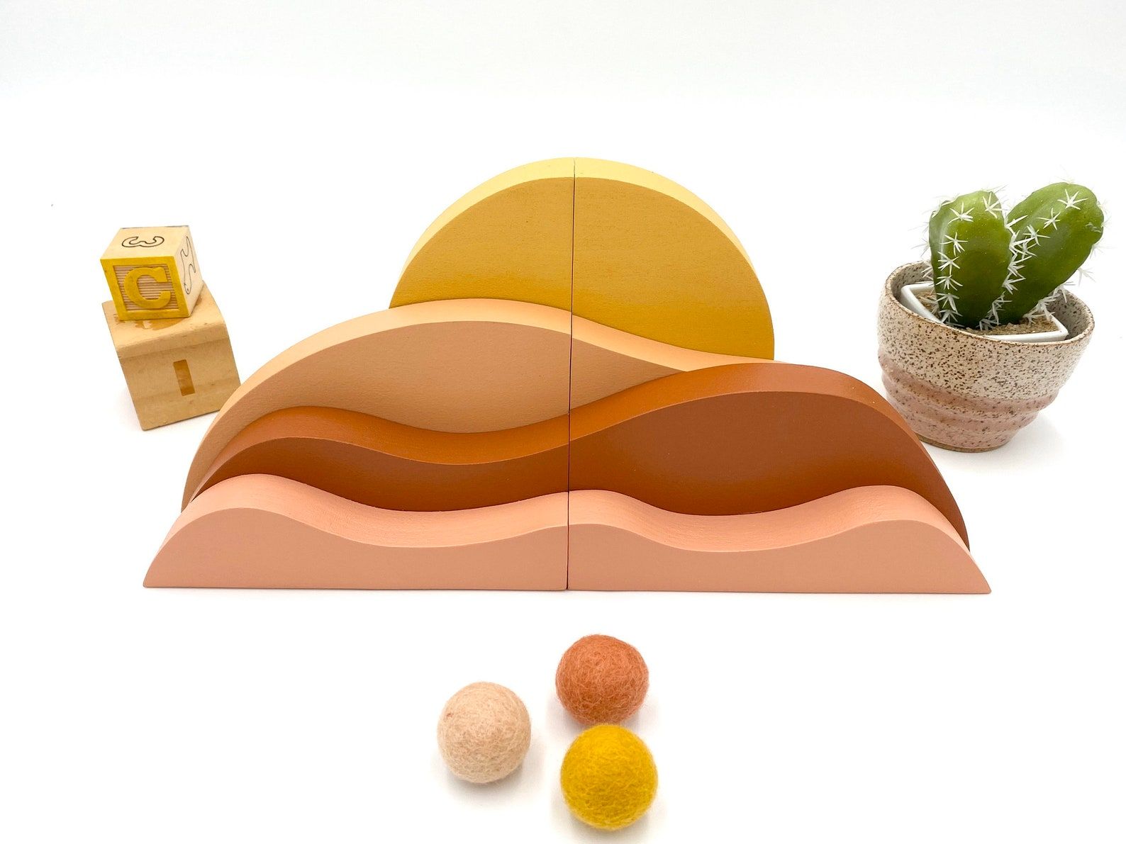 Image of a set of bookends that look like a desert sunsset. 