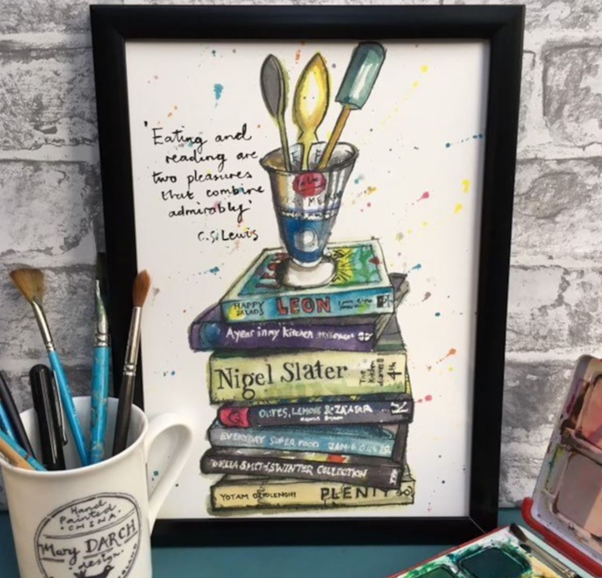 Image of a print that features a stack of cookbooks and a CS Lewis quote.