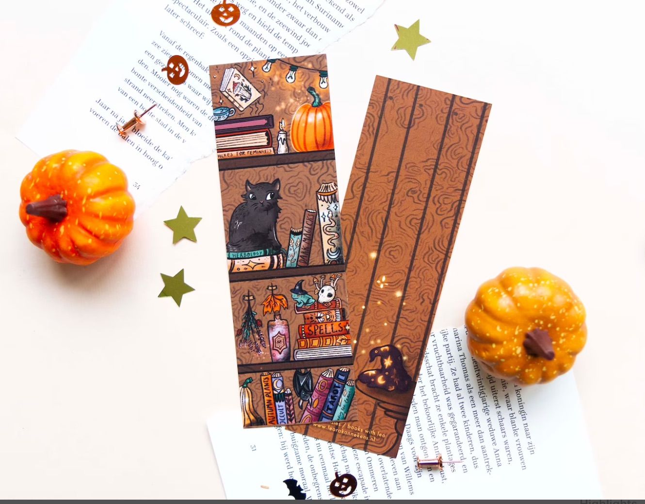 Image of both sides of a bookmark, on a white background, with two mini pumpkins. The front of the bookmark is a magical, witchy bookshelf, and the back features a witch's hat and stars. 