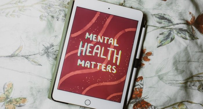 Image of an ipad with art on it reading "mental health matters."