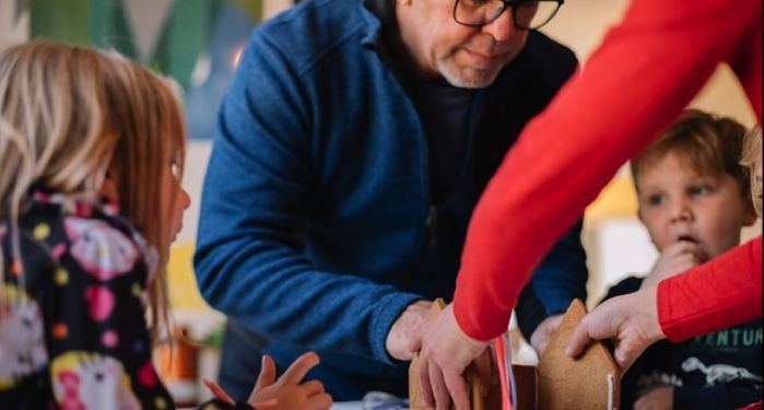 image of kids making ginger bread house with grandparents