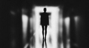eerie black and white image of a person in silhouette