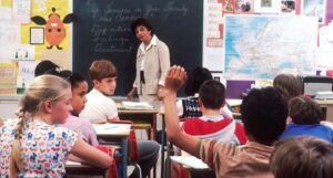 image of a middle school classroom with students and a teacher