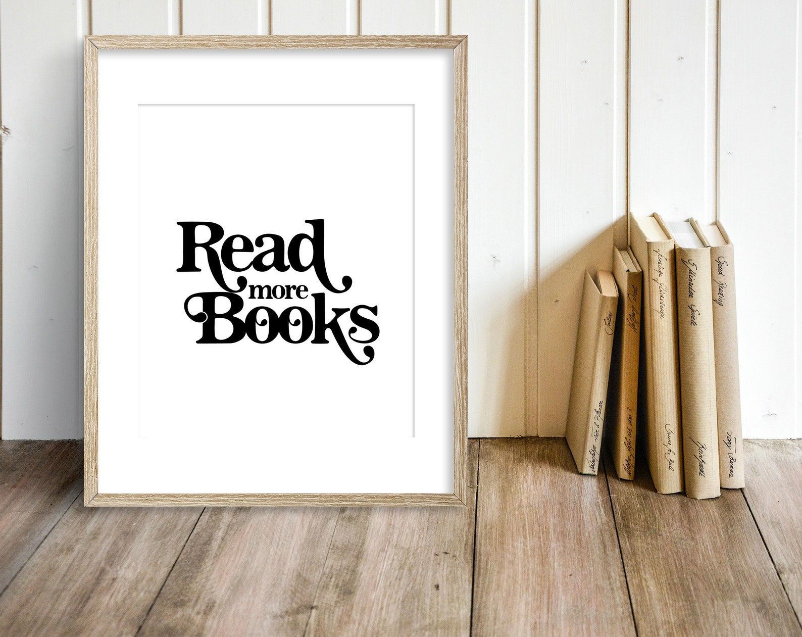 White print with the words "read more books" in a swoopy, 70s font. 