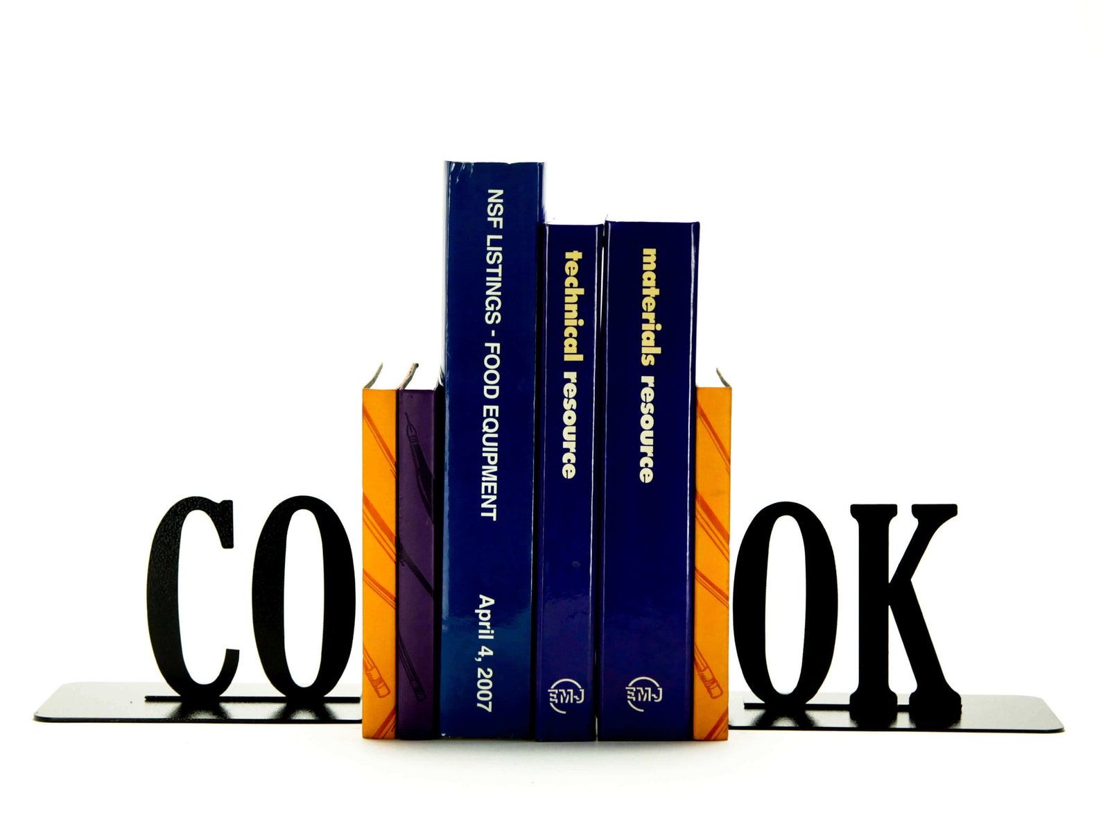 Black steel bookends holding up several cookbooks. The one on the left has the letters "CO" and the one on the right the letters "OK".