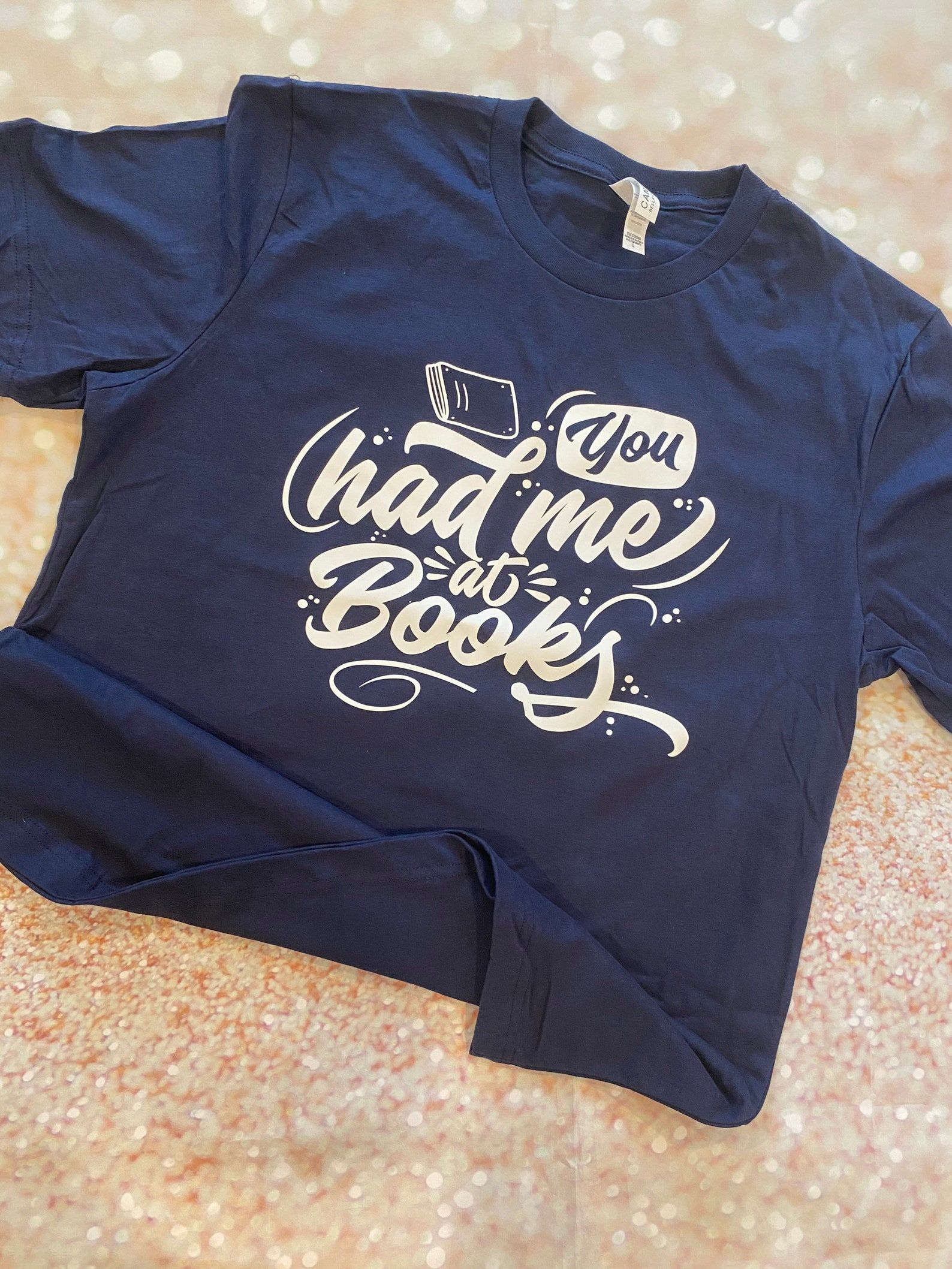 Image of a blue shirt that reads, in script font, 