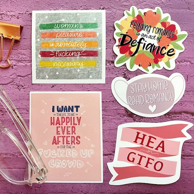 Five vinyl stickers. The first says "womxn's pleasure is absolutely fuckign necessary." The second says "reading romance is an act of defiance." Third says "Stay home, read romance," fourth says "HEA or GTFO," and fifth says "I want there to be happily ever afters for the fucked up crowd." 