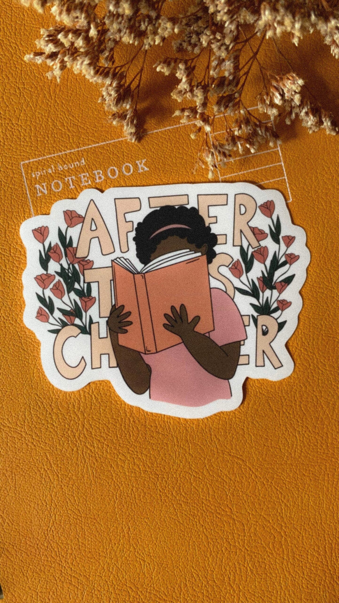 Image of a sticker featuring a Black reader with an open book. Behind the reader are the words 