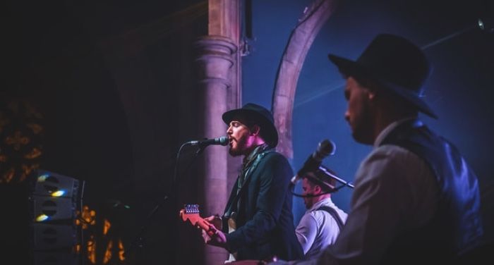 two men in a band playing on stage