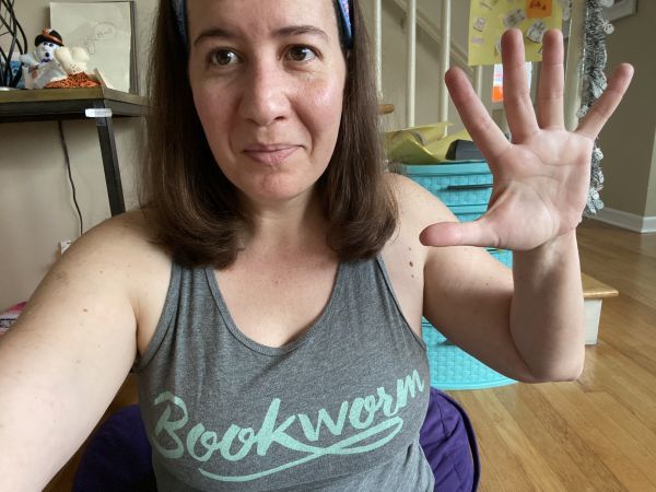 author of post wearing a Bookworm tank top and waving