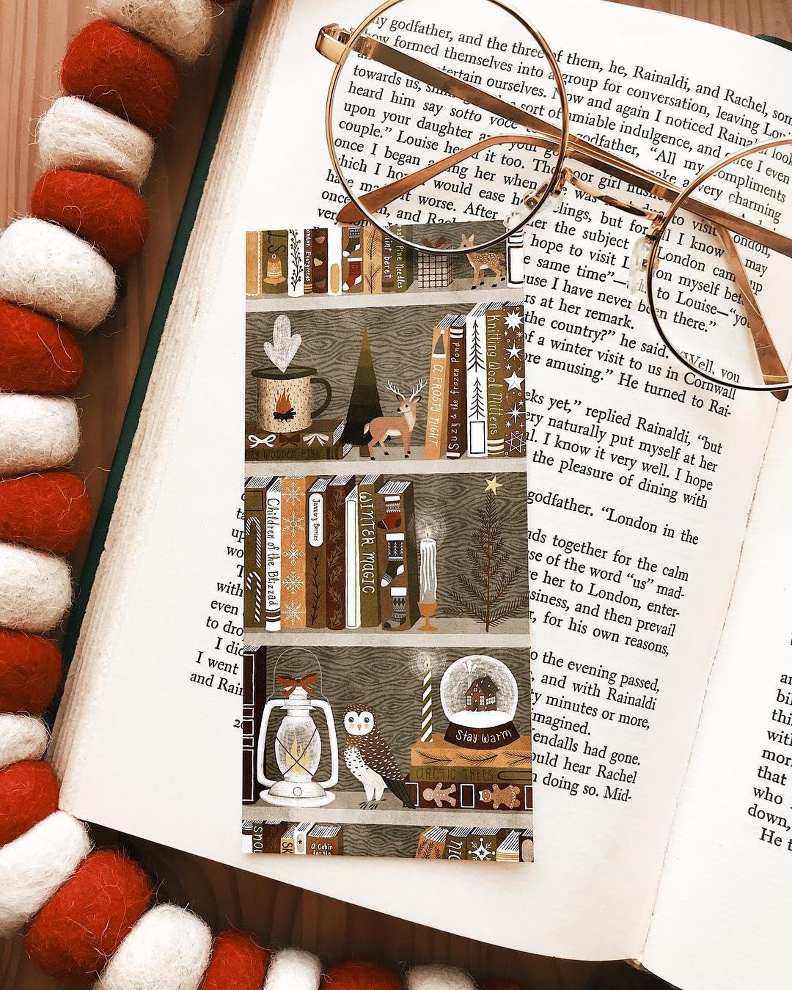 Image of a bookmark featuring brown bookshelves loaded with books and holiday ephemera. 