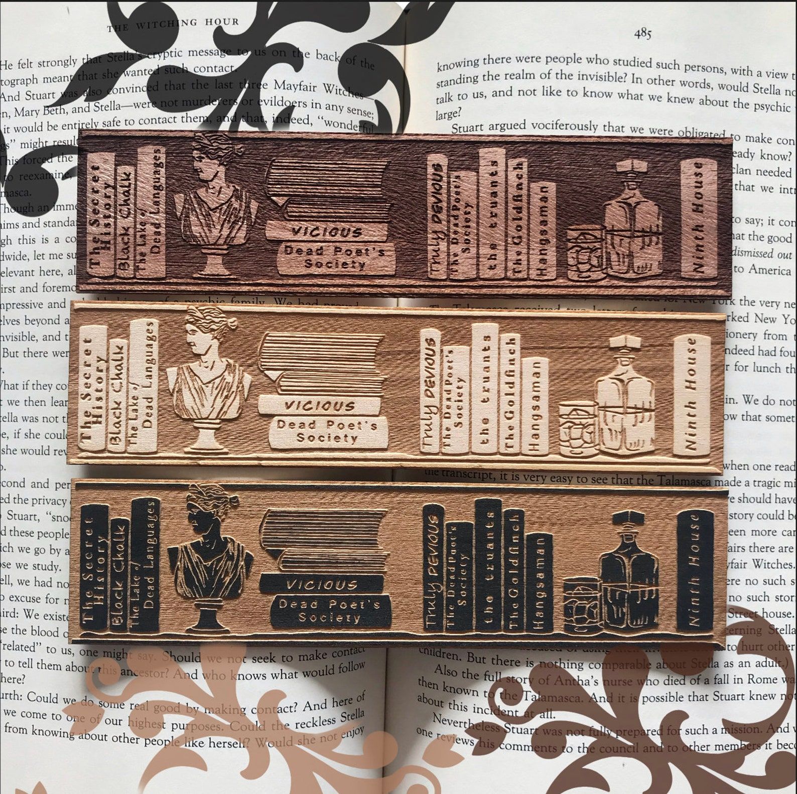 A trio of three wooden bookmarks in various wood times displaying a carved selection of Dark Academia book spices including The Secret History, Vicious, Ninth House, Truly Devius, The Truants, and more.