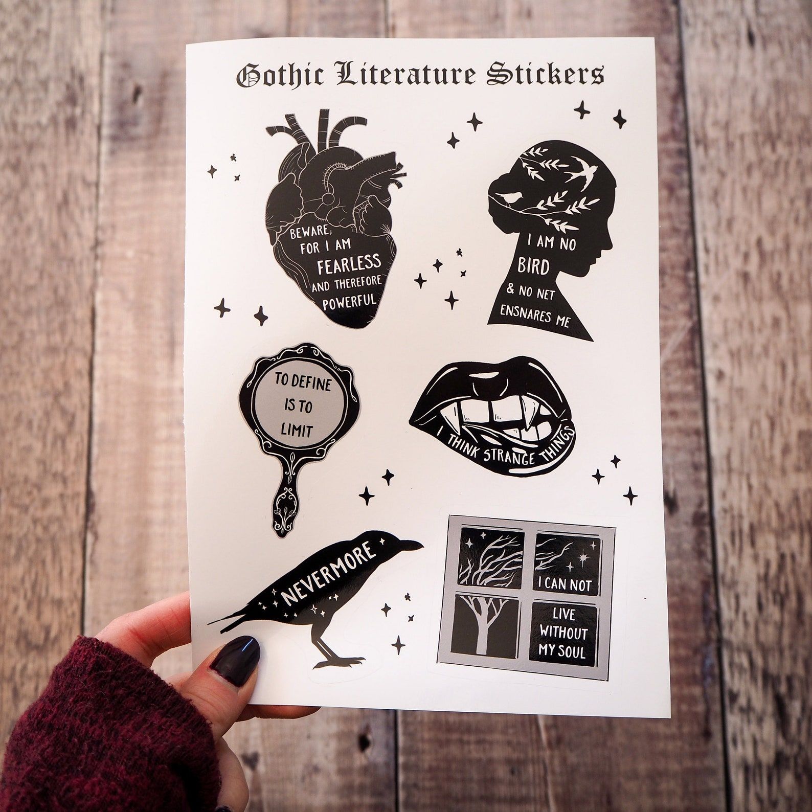A sticker sheet full of black and white stickers with quotes from literary Gothic classics.