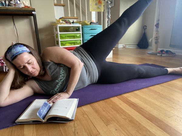 author reading while doing leg raises